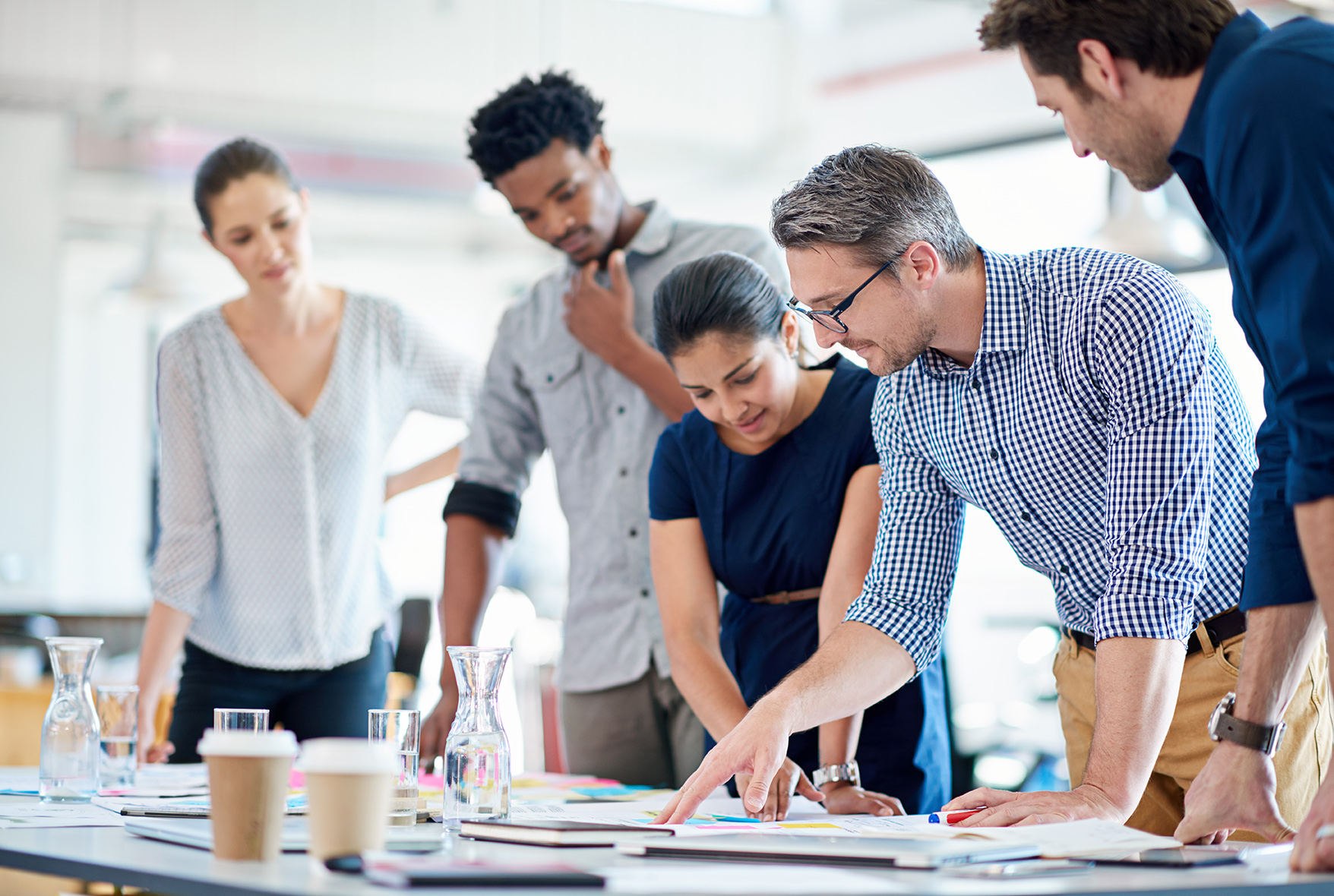 Man describing a plan of action to his diverse creative team.